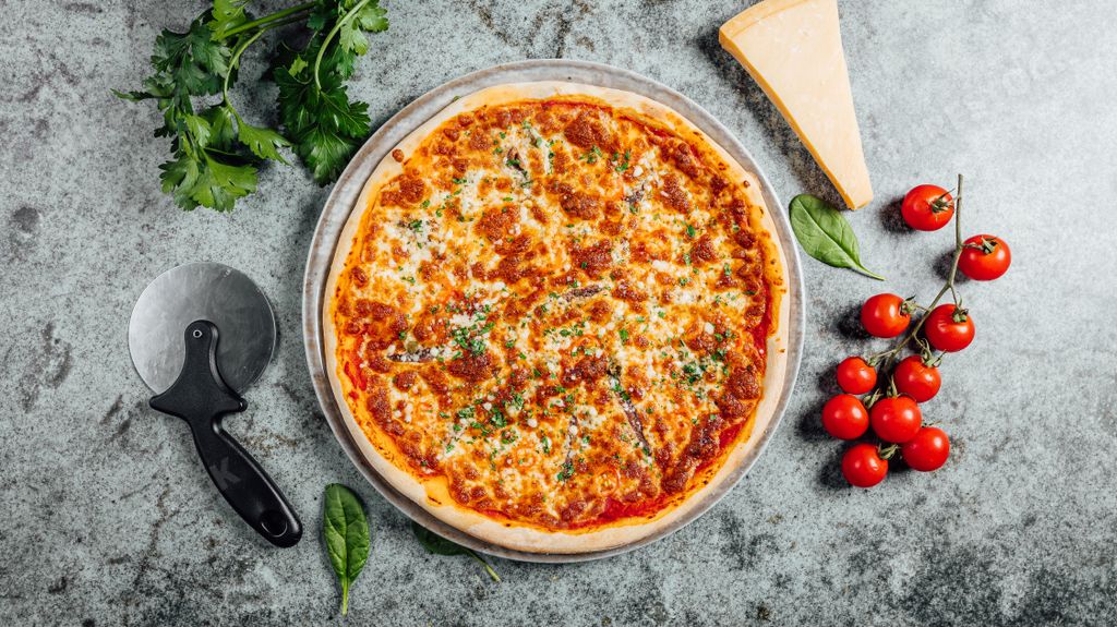 A top view of a beautiful and delicious pizza with vegetables and cheese