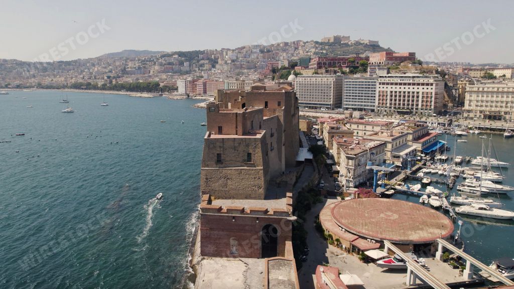 A bird's eye view of the Ovo Castle against the Tyrrhenian Sea in Naples, Italy