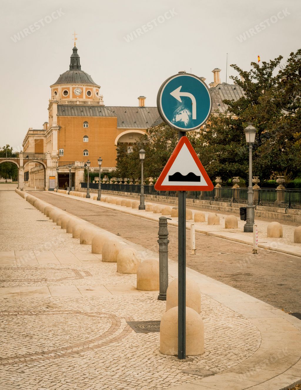 A closeup of road sign in background of palace Aranjuez in Spain