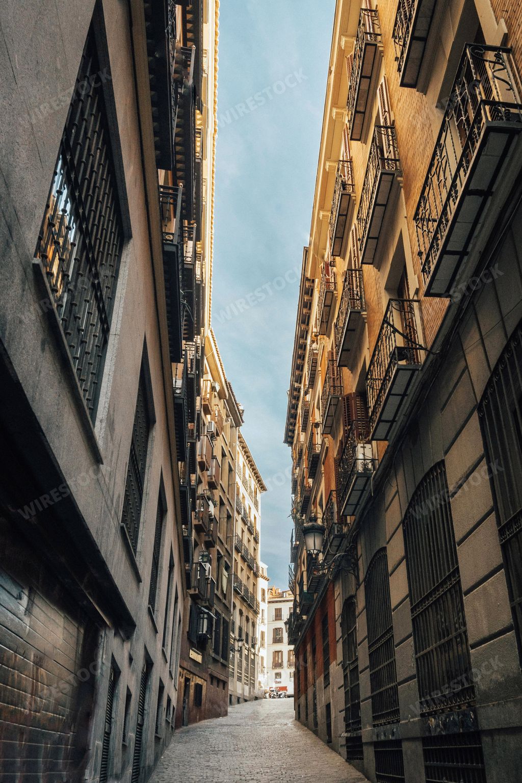 A vertical shot of a narrow European-style alley in Madrid, Spain