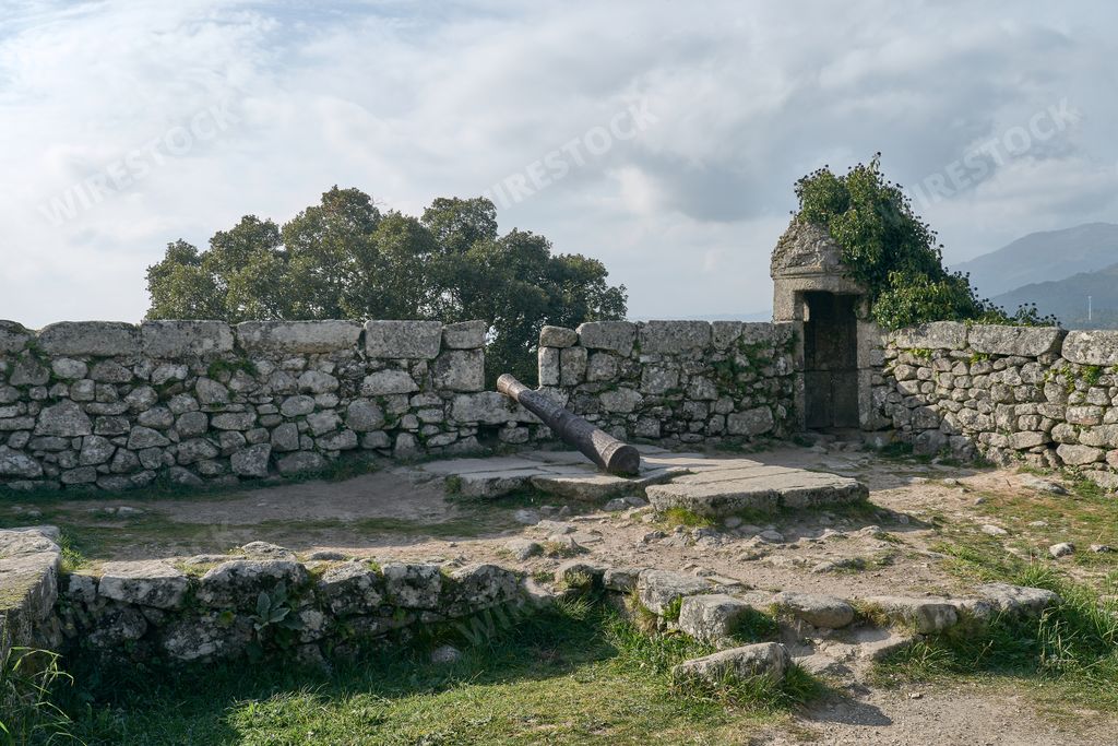 View of the walls of a old castle with a cannon  and a sentry box, Portugal.