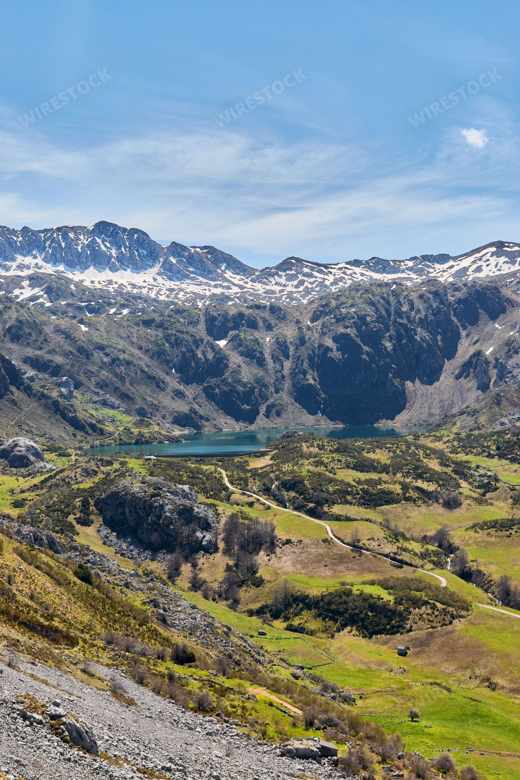 An aerial view of mountain landscape under blue bright sky