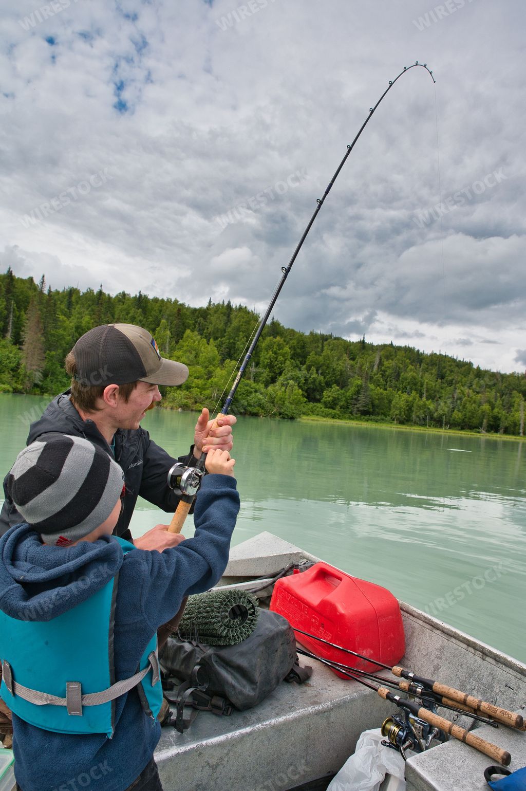 A vertical of tourists fishing for salmon in Big River Lake, Alaska