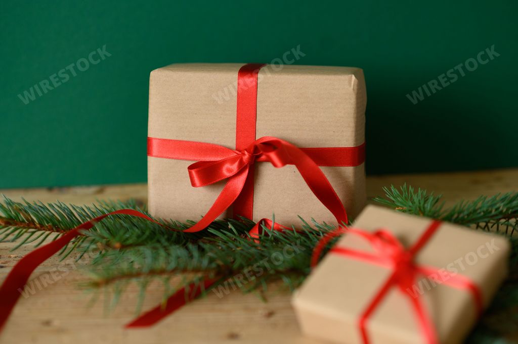 A closeup shot of Christmas presents against a green background