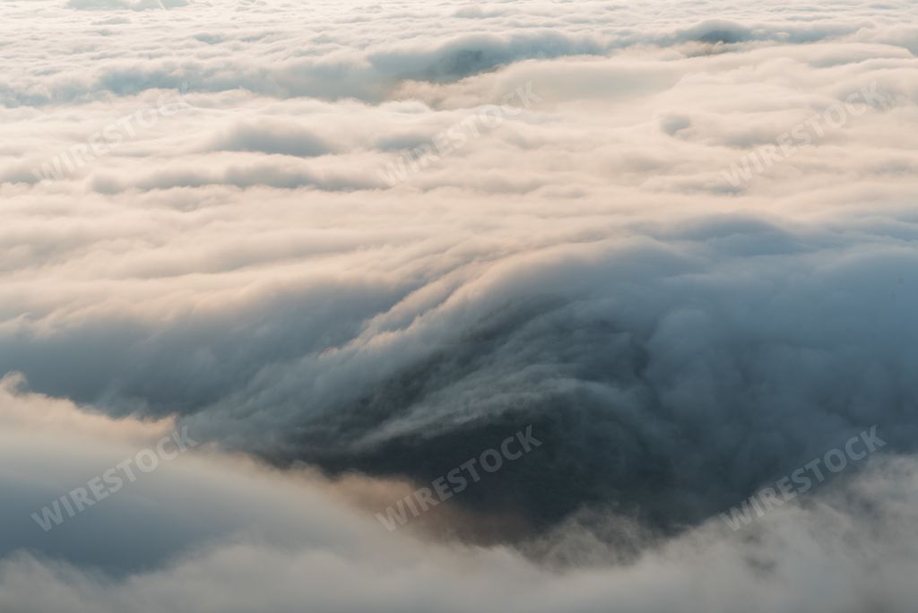 The mountains with clouds over them covered with fog