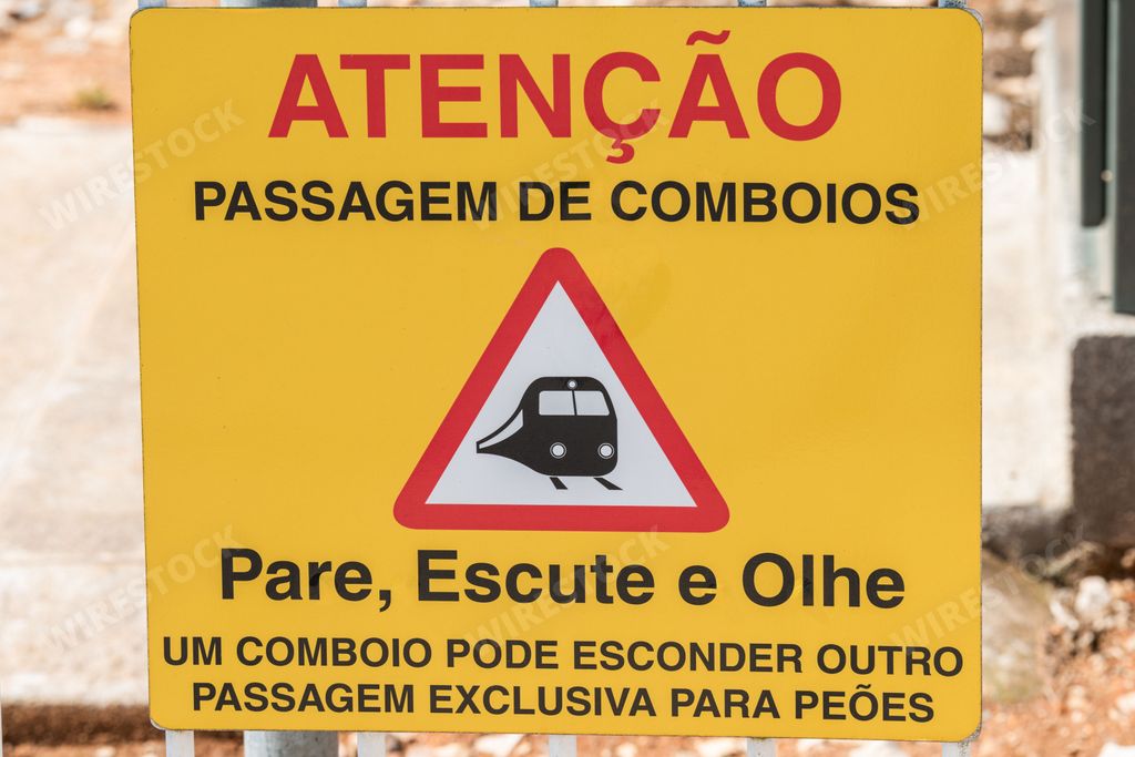 A Yellow caution warning information sign when crossing the train line with blurred background