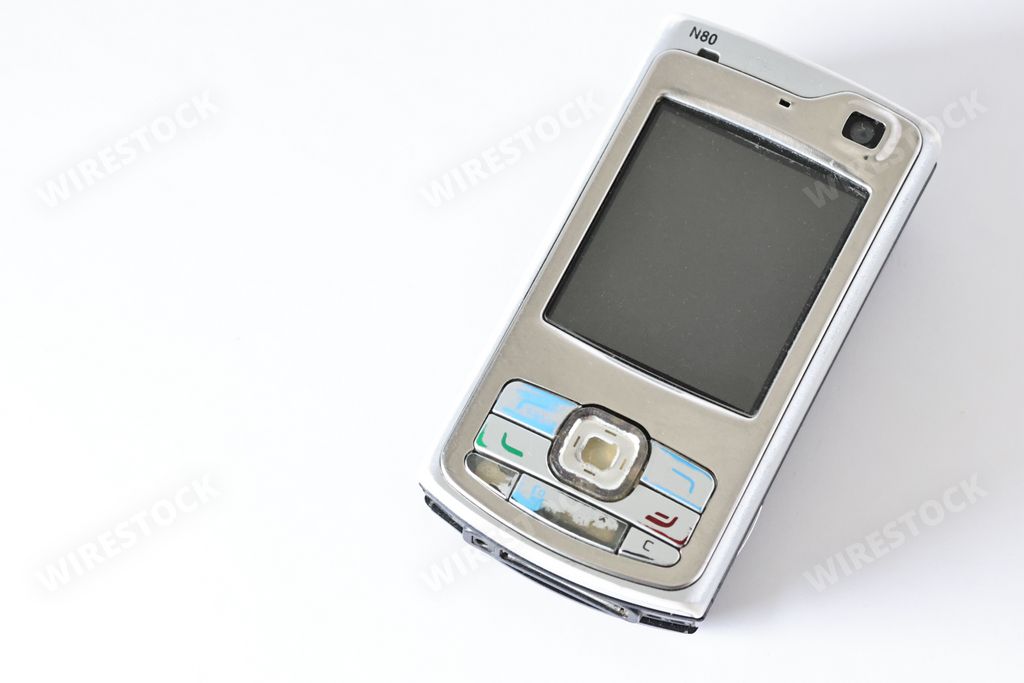 A historic Nokia N70 GSM UMTS phone on a white surface