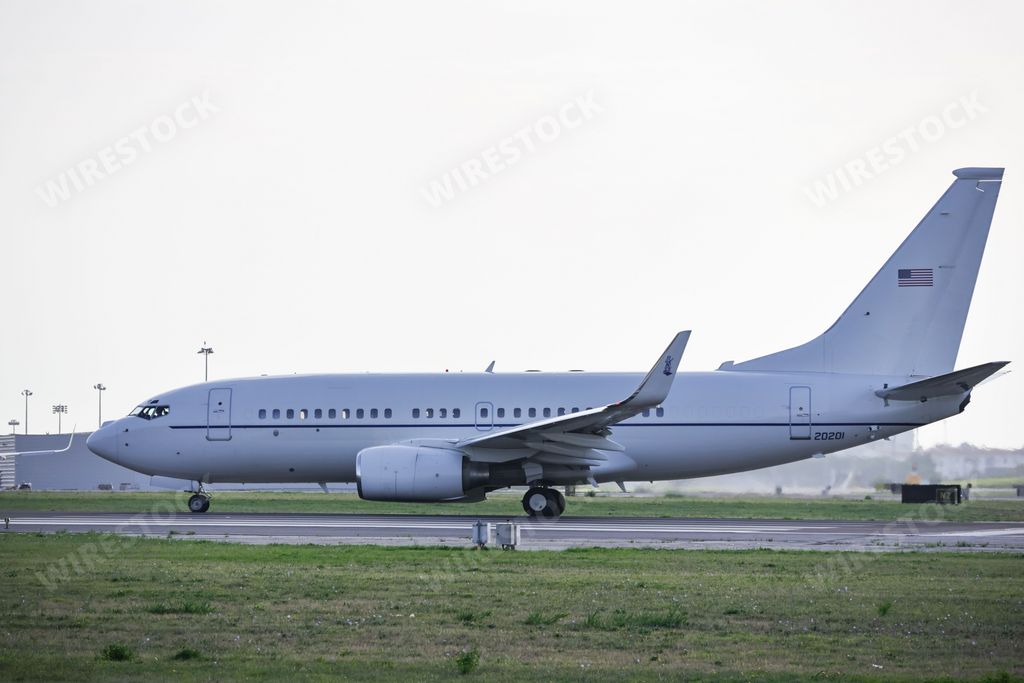 A Boeing C-40C airplane of the US Air Force, at Lisbon airport at sunrise, surrounded by green lawn