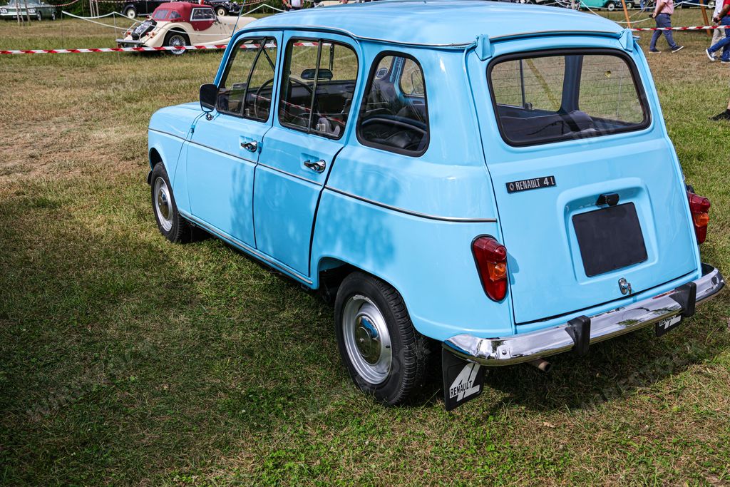 A blue Renault 4 vintage car parked in a park