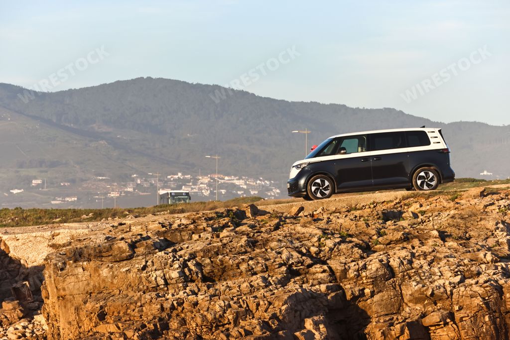 A stunning shot of the new electric version of the Volkswagen ID Buzz minivan, on a rocky hill