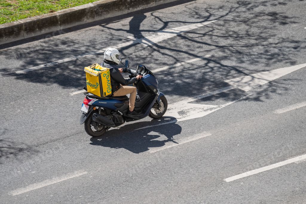 A photo of Glovo company courier, a service for the collection and delivery of ordered products