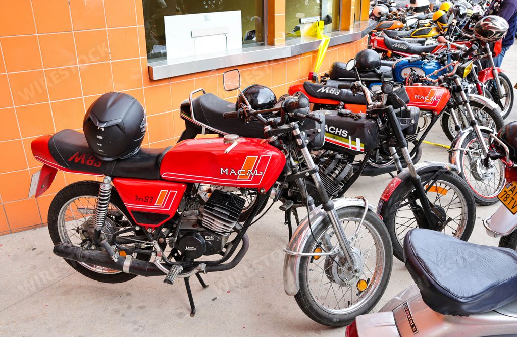 The classic Vespa, zundapp, Famel XF, Piaggio, and Sachs V5 motorcycles on display on a street