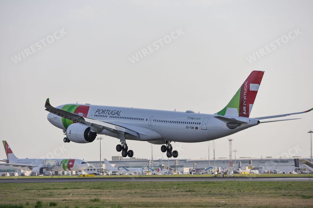 An Airbus A330-941 airplane of the TAP Air Portugal airline, at Lisbon airport, landing at sunrise