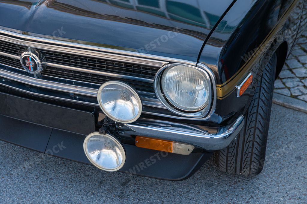 A closeup of the front of a beautiful shiny Nissan Datsun 1200 car