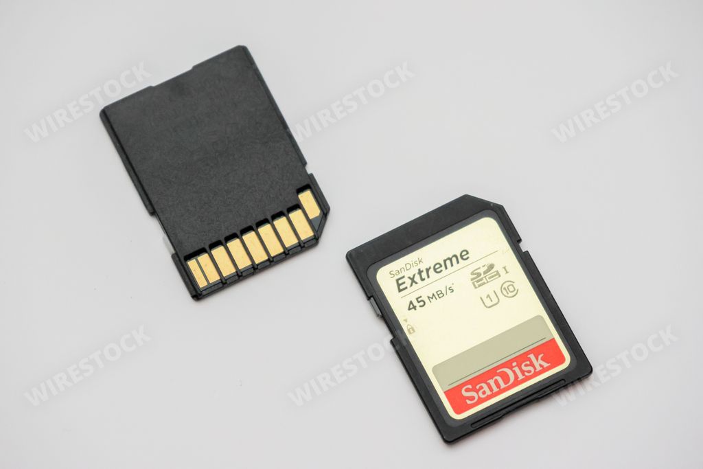 An SD memory card from Sandisk manufacturer on a white background