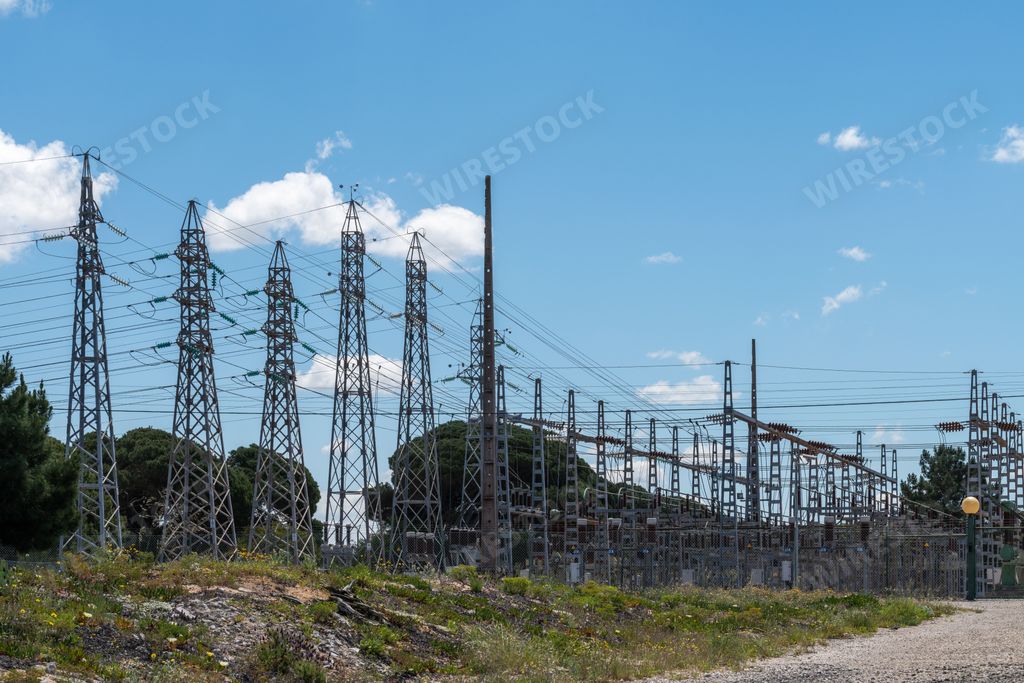 A view of utility poles in an electrical power station on a sunny day