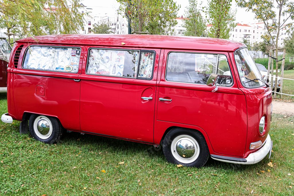 A red Kombi van from the Volkswagen manufacturer completely restored during an exhibition in a park