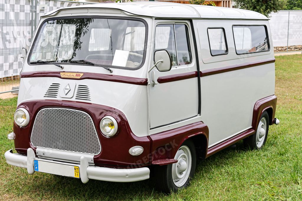 A front view of a beautiful classic white Renault Estafette van in a fiel
