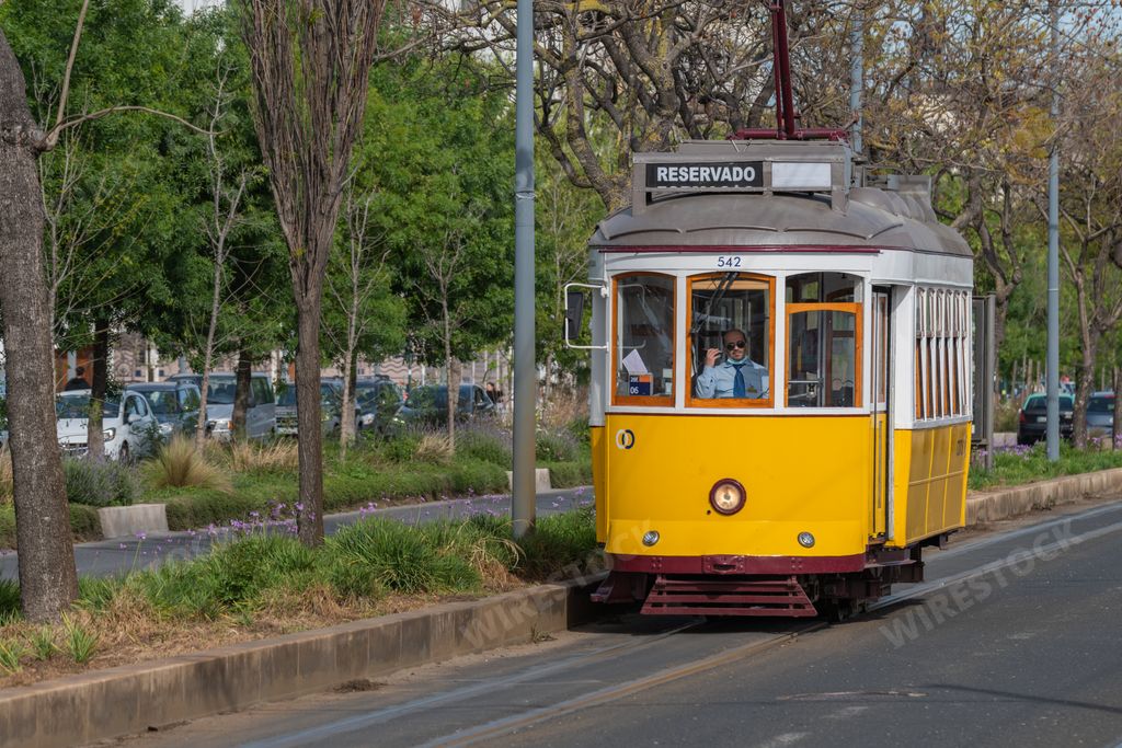 An old historical yellow tram at the Avenida 24 de Julho street in Lisbon, Portugal