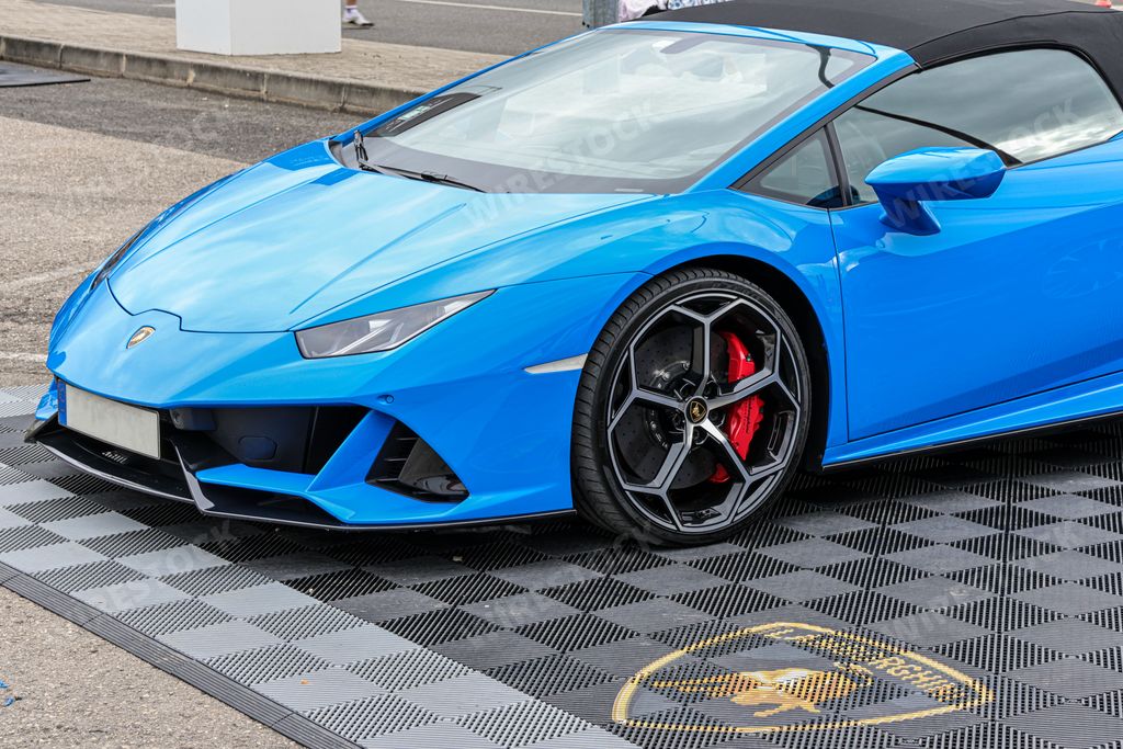 A side view of a beautiful blue Lamborghini Huracan on a sunny day