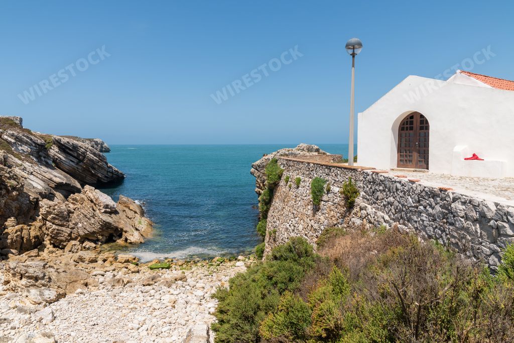A scenic view of St. Stephen's Chapel against the sea in Baleal, Peniche, Portugal