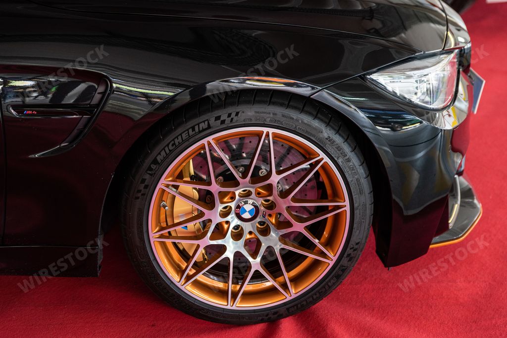 A close-up shot of a rim detail of the powerful BMW M4 car.