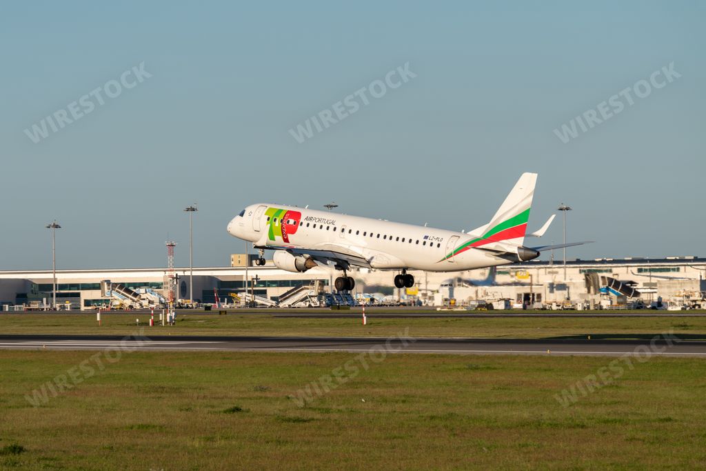 The Airplane Embraer E190STD of the TAP Express airline landing at Lisbon airport