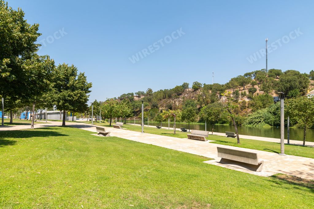 Wooden benches next to a river in Ponte de Sor city, Portugal