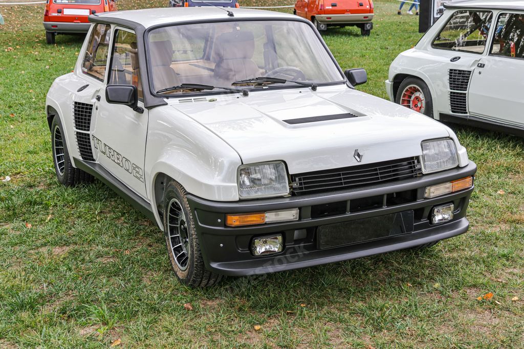 A closeup of details of white vintage historic Renault 5 Turbo 2 car surrounded by other cars