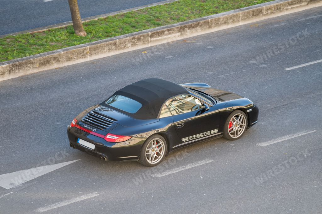 A photo of a Porsche 911 Carrera 4S sports car on the streets of Lisbon
