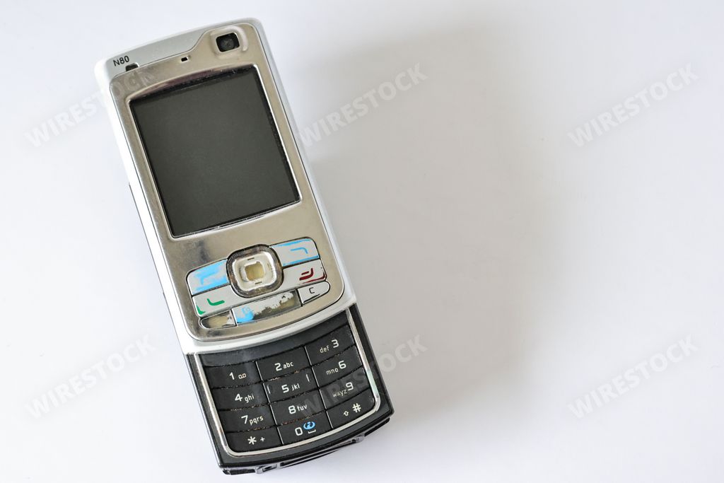A historic Nokia N70 GSM UMTS phone on a white surface