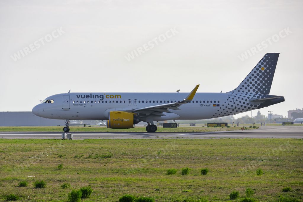 An Airbus A320-271N airplane of the Vueling airline, at Lisbon airport, landing at sunrise