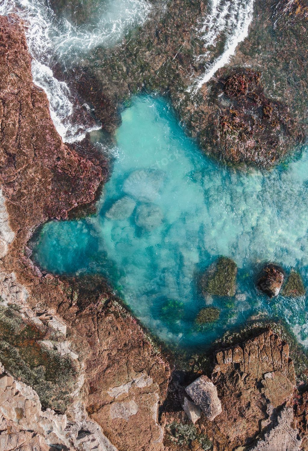 A drone shot of a rock pool on the Garie Beach in Royal National Park, Australia