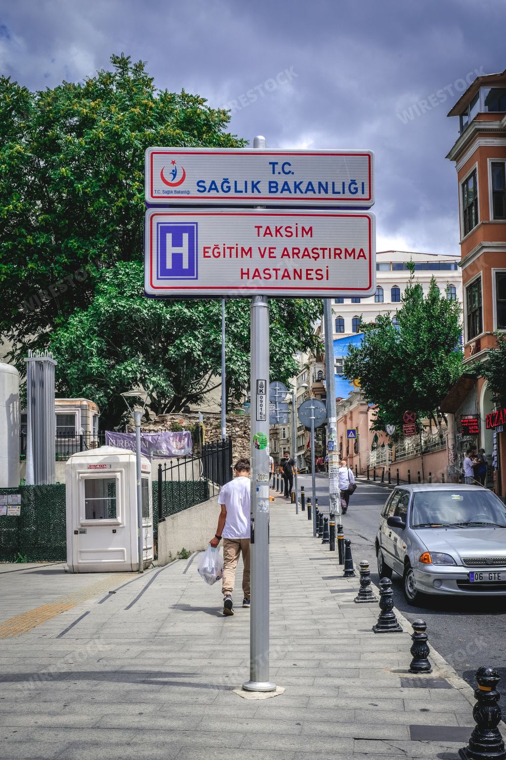 A vertical shot of the Taksim Training and Research Hospital road sign in Istanbul, Turkey