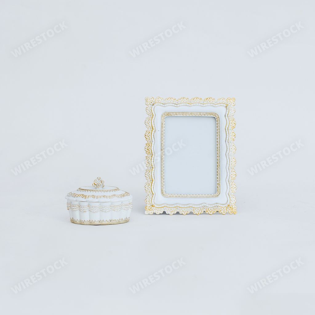 An old-fashioned photo frame and a casket on a white background