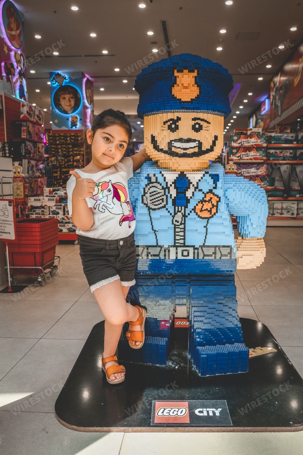 A little sweet girl with a Lego hero in a toy shop, Istanbul, Turkey