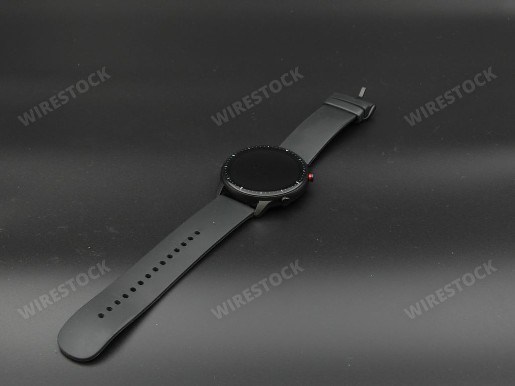 A closeup of a smart watch on a black background