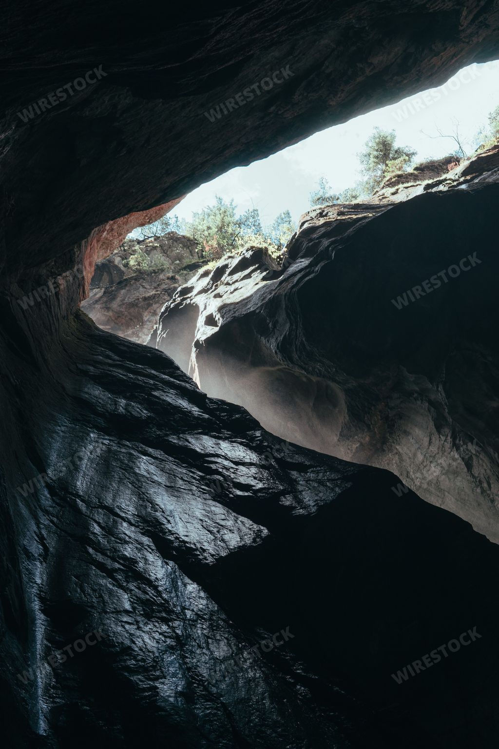 A vertical shot of the dark rocks in a cave