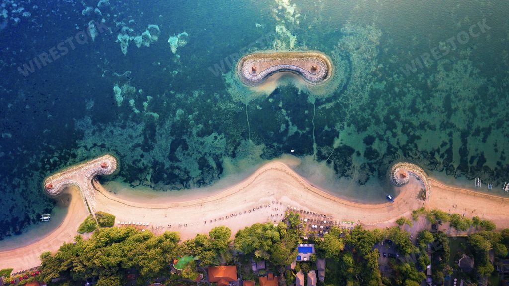 An aerial shot of the Karang beach surrounded by the sea and greenery in Sanur, Bali