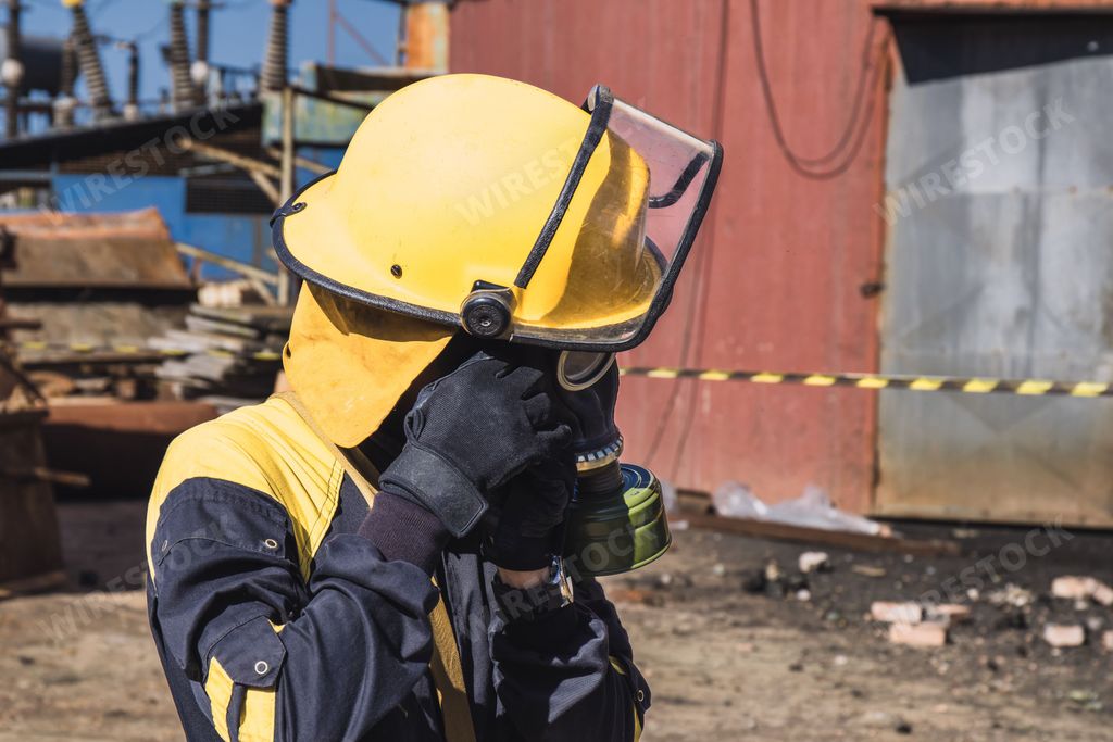 A closeup image of a Cuban firefighter preparing their protective gas mask gear before responding to an emergency