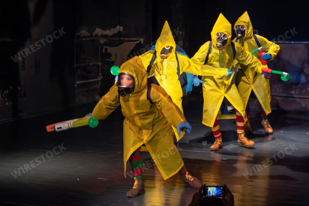 Young theater actors in a clown play in virus preventing robes during coronavirus in Matanzas, Cuba