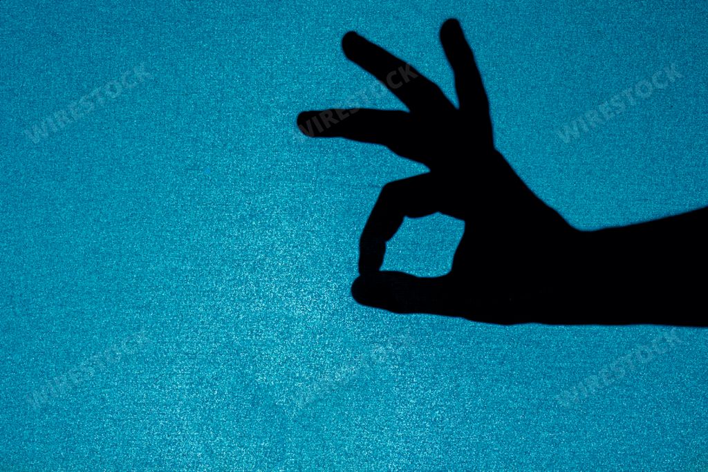 A Hand of a person gesturing with the OK sign