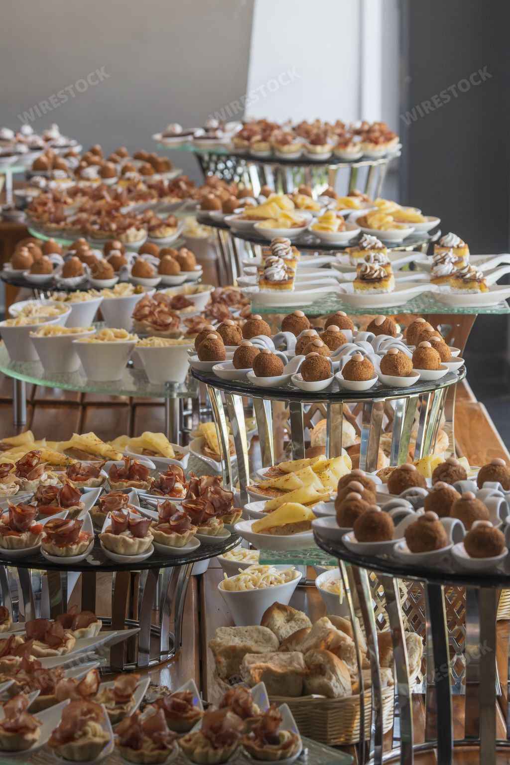 A buffet table with the plates of desserts and snacks, a vertical shot