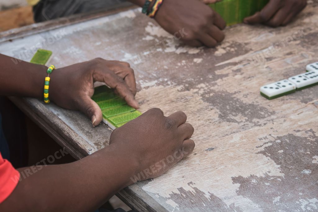 A closeup of black hands playing dominoes in the neighborhood of La Marina Matanzas, Cuba