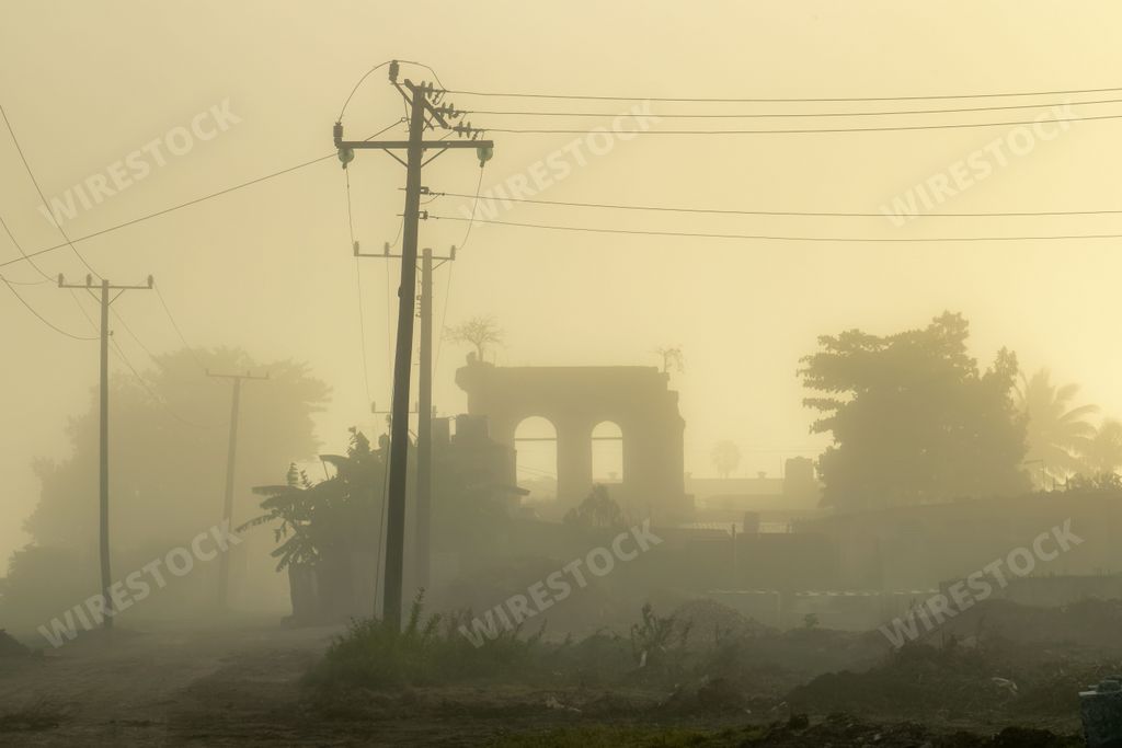 Idyllic countryside landscape featuring a foggy atmosphere with a power line stretching out into the distance