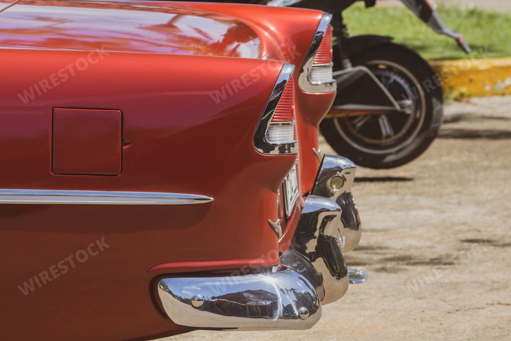 A closeup shot of a detail of an old red chevrolet car