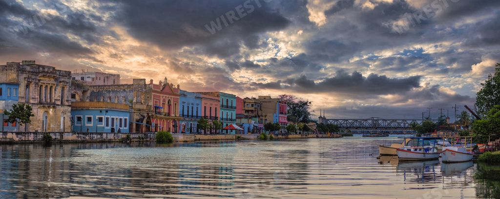 The San Juan River in Matanzas, Cuba under a cloudy bright sky with colorful buildings around