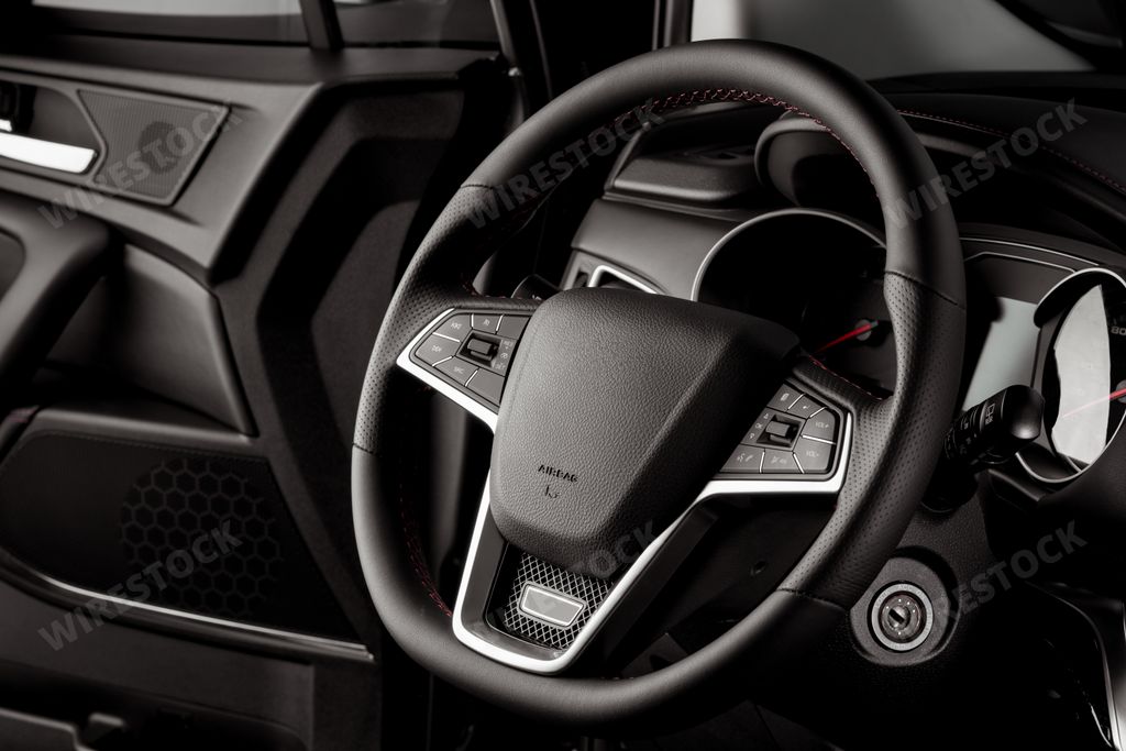 The leather-covered steering wheel of a new SUV