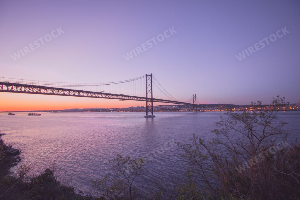 A beautiful view of the Ponte 25 de Abril suspension bridge in Portugal during sunset