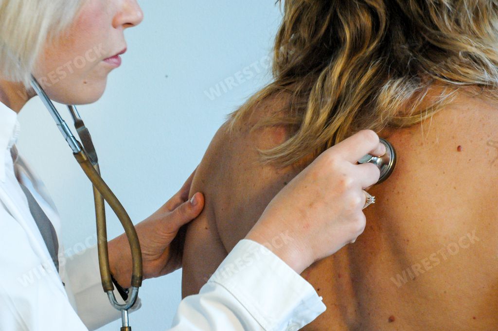 A doctor examining a patient with stethoscope